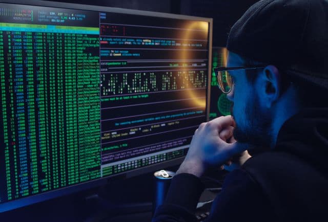 Founder reviewing remote data engineer candidate profiles on a laptop with a pipeline diagram in the background