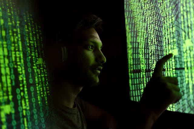 Cybersecurity analyst monitoring SIEM dashboards remotely with multiple security alerts displayed